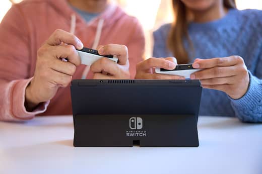 People are playing Big Brain Academy: Brain vs. Brain in tabletop mode on a Nintendo Switch system.